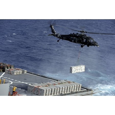 Military Sealift Command Ships - Atlantic Ocean January 15 2013 - An MH-60S Sea Hawk helicopter picks up ammunition from the Military Sealift Command dry cargo and ammunition ship USNS William McLean Poster Print