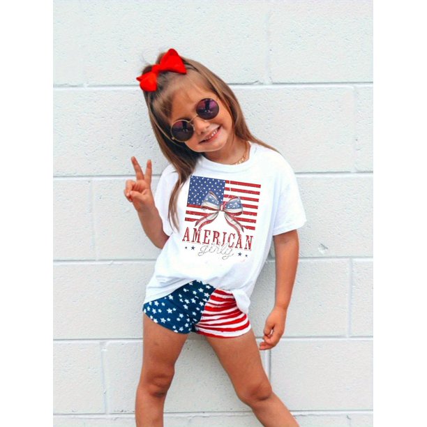 Camiseta 100 % algodón con estampado de la bandera estadounidense patriótica para niña. Top informal de verano de corte holgado con lazo rojo para celebraciones y decoraciones del 4 de julio.