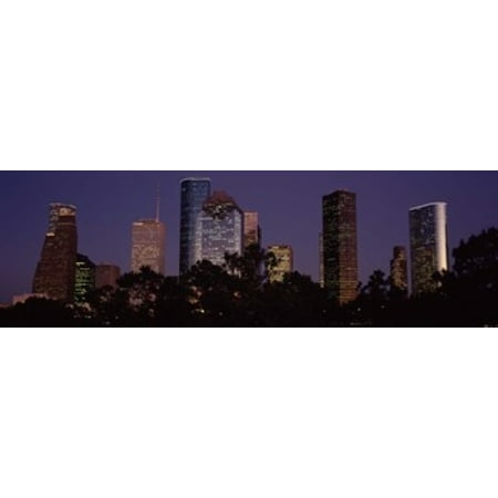 Buildings in a city lit up at dusk Houston Harris county Texas USA Poster