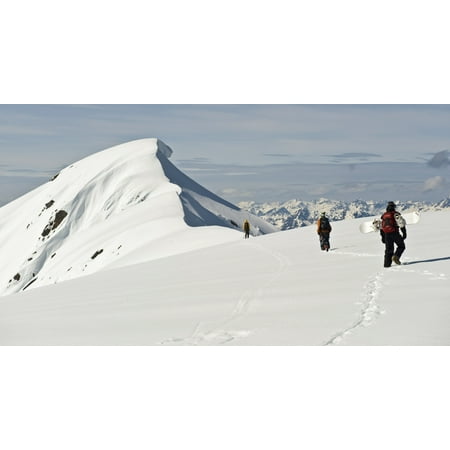 A Corniced Mt Hawthorne Rises In The Background As Skiers And A Snowboarder Hike To Get A Better View Of The Summit While Heli-Skiing Near Juneau Alaska Canvas Art - Chris Miller  Design Pics (21 x