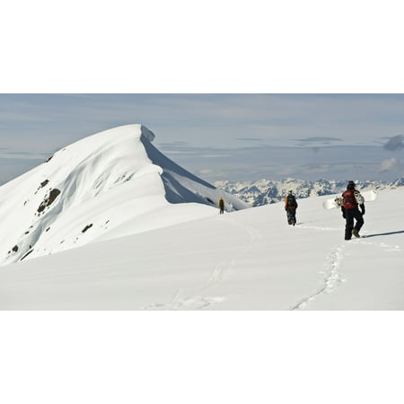 A Corniced Mt Hawthorne Rises In The Background As Skiers And A Snowboarder Hike To Get A Better View Of The Summit While Heli-Skiing Near Juneau Alaska PosterPrint