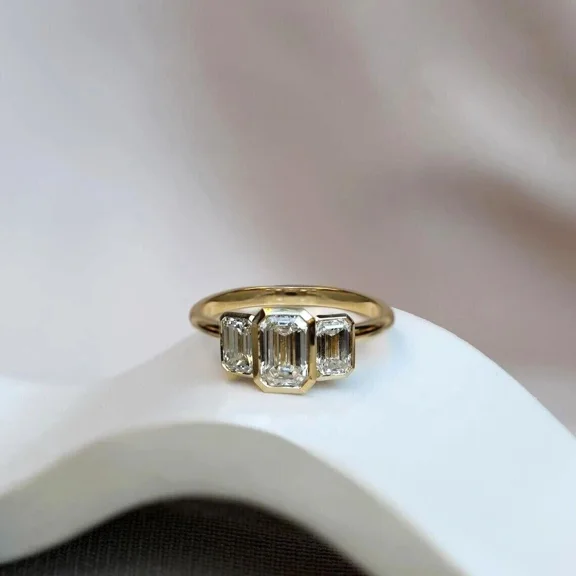 Bezel Set 2Ct Emerald Cut Lab Created Diamond Three-Stone Ring in 14k Yellow Gold Plated