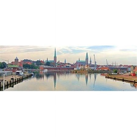 Panoramic Images Buildings at the waterfront with church towers in distance Trave River Lubeck Schleswig-Holstein Germany Poster Print by Panoramic Images - 36 x 12