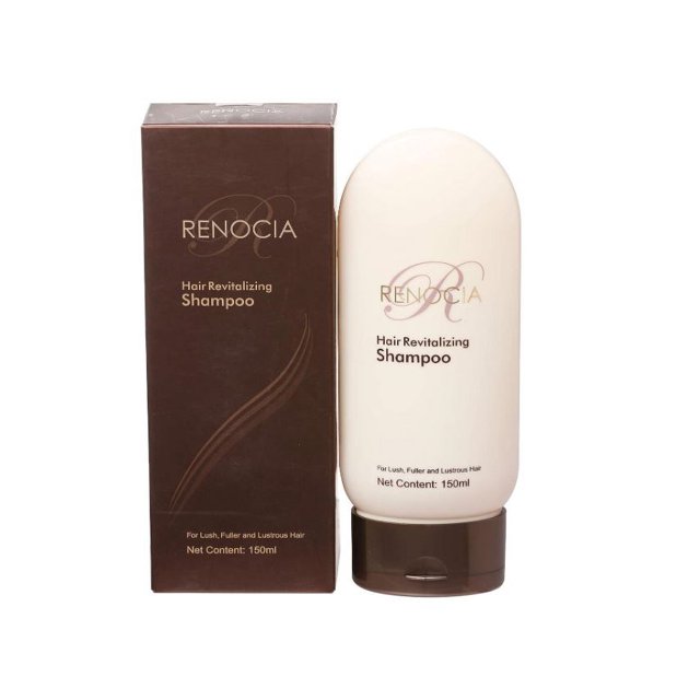 Renocia Hair Revitalizing Shampoo 150 ml bottle displayed next to its brown packaging box. The shampoo is designed to stimulate hair growth, nourish the roots and scalp, and protect against pollution and dust. The bottle features a sleek design with a cream-colored body and brown cap.