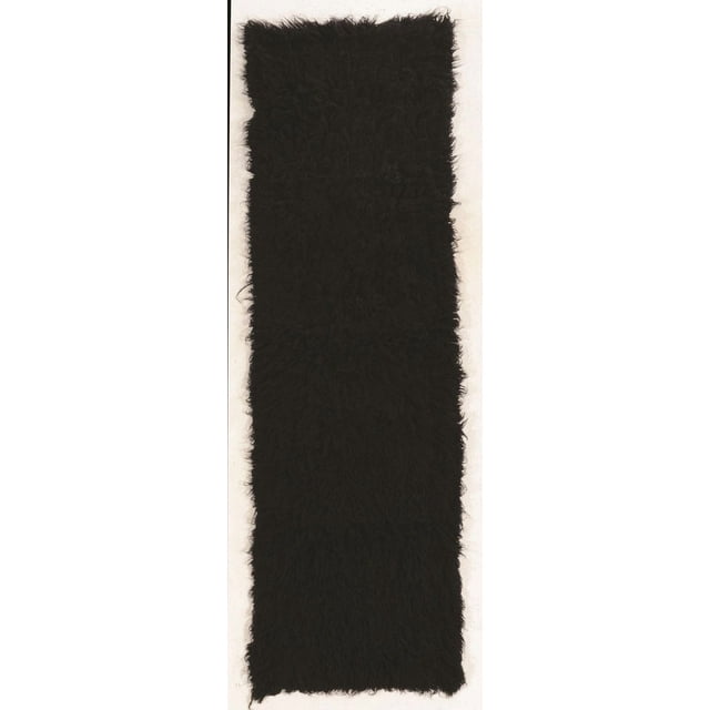 Black Flokati runner rug with dense, shaggy wool fibers measuring 2 feet 4 inches by 8 feet 6 inches.