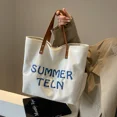 thumbnail image 5 of Bolso de lona versátil con letras bordadas para mujer, bolso de mano de gran capacidad para desplazamientos y ocio, bolso de hombro de moda Paquete de fotos, 5 of 5