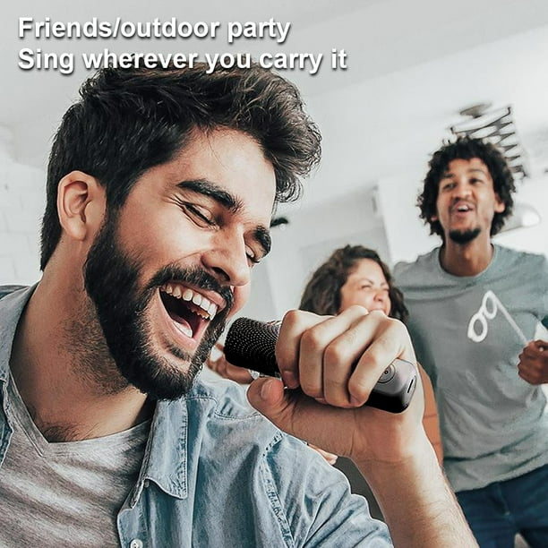 Black portable speaker with microphones included.
