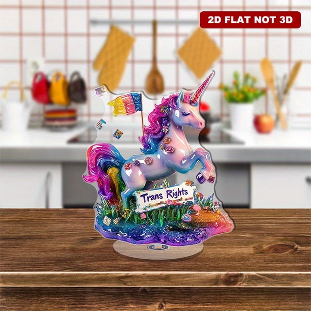 Rotating acrylic display featuring a unicorn with a Trans Rights sign on glitter grass adorned with translucent resin layers and falling transgender flags