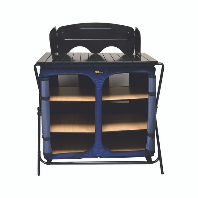Faulkner Table 49583 Camp Cuisine Table/Cupboard with a foldable design, featuring a sturdy aluminum tubing frame, aluminum panel surface, and 600D polyester fabric. The table includes three cabinet shelves, each with a 20-pound weight capacity, and a top surface with a wind deflector for camp stove protection. Zippered doors secure the shelves, keeping supplies clean and bug-free. The table measures 32 inches in height, 35 inches in width, and 22 inches in depth when open, and folds down for portability with an included carry bag. Multicolour design suitable for camping and outdoor use.