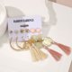 thumbnail image 4 of Conjunto de seis pares de pendientes con borlas de perlas y flores de estilo bohemio., 4 of 7