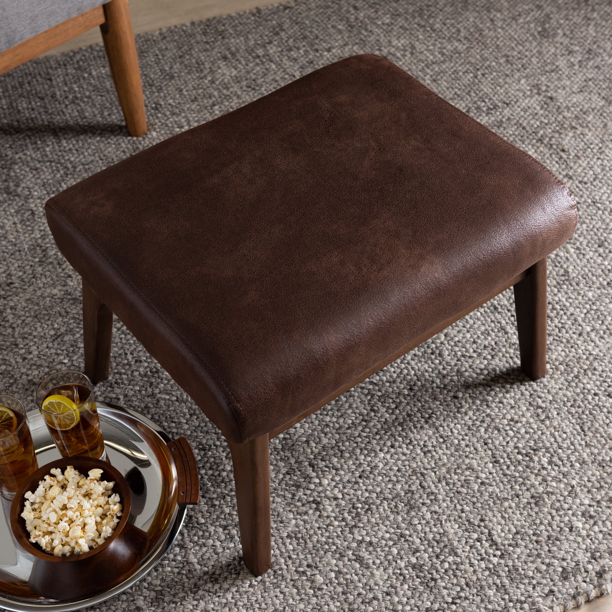 Bakari Mid-Century Modern Walnut Wood Dark Brown Distressed Faux Leather Ottoman by Bellamy Studios