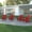 Red, variant on Emma + Oliver Set of 4 Adirondack Chairs with Cup Holders, Weather Resistant HDPE Adirondack Chairs in Red