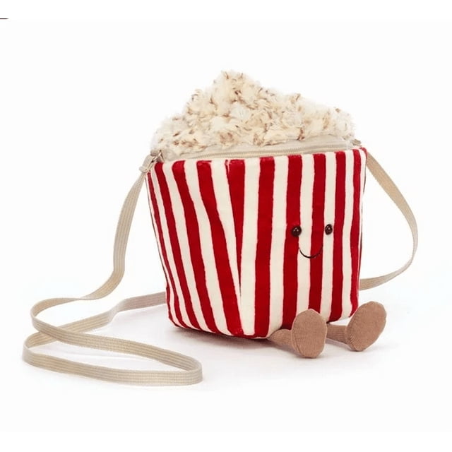 jellycat amuseables popcorn bag - classic gifts series, soft plush toy stuffed animal, cute popcorn plushie gift for kids, unique collectible for children, adorable plush gift amuseables popcorn bag bolsa tipo bandolera con rayas rojas y blancas, vista frontal centrada; forma de cubo blando con cierre superior y relleno que simula palomitas color crema, carita bordada con ojos negros y sonrisa, patas pequeñas y correa beige larga sobre fondo blanco; también se utiliza como accesorio de juego o bolsa pequeña para llevar juguetes.