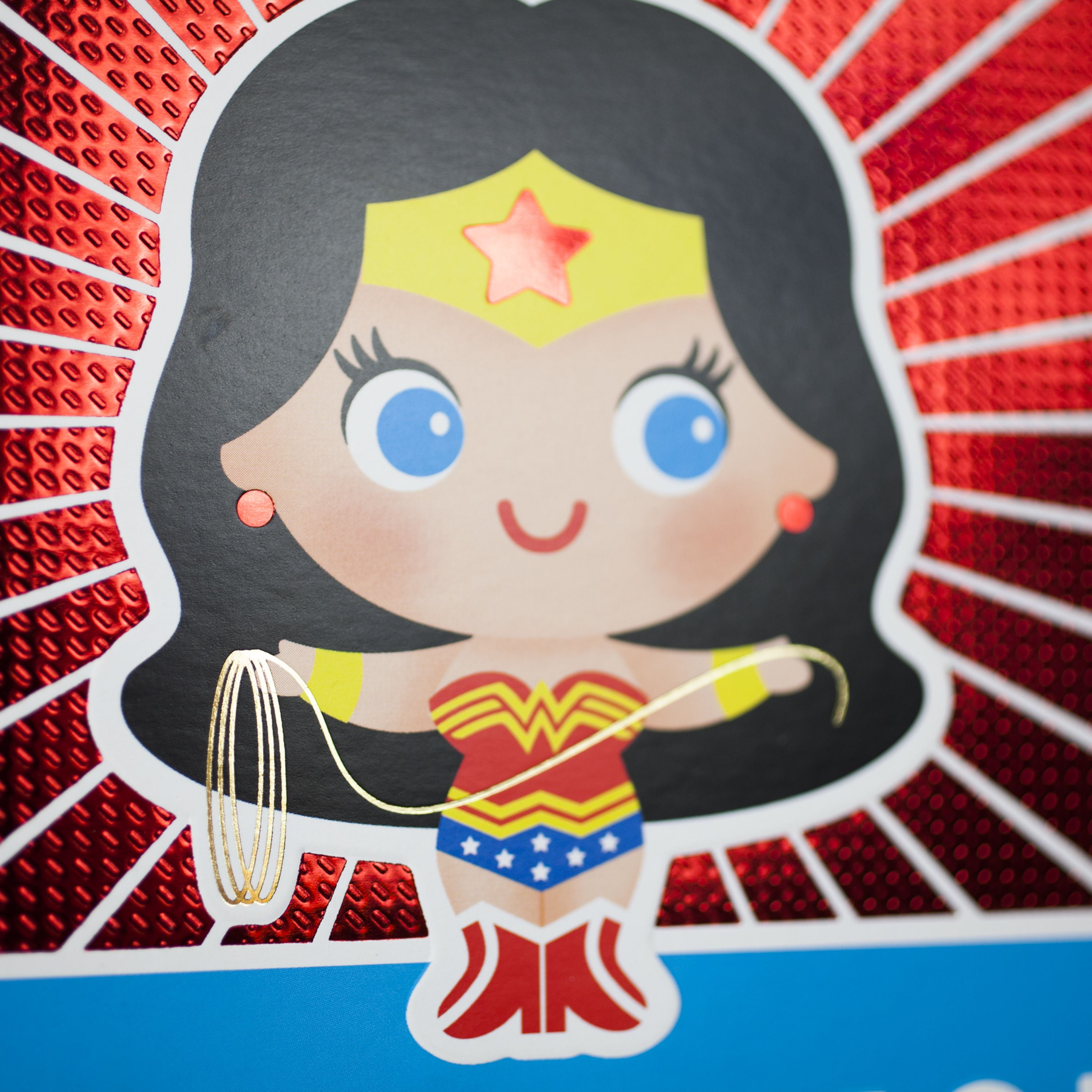 A game card of wonder woman with decorated borders and icons, in