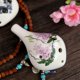 thumbnail image 2 of Ocarina de cerámica en tono Do alto, pintada a mano con diseño de flores, incluye partitura y cordón para colgar. Ideal para amantes de la música y principiantes., 2 of 6