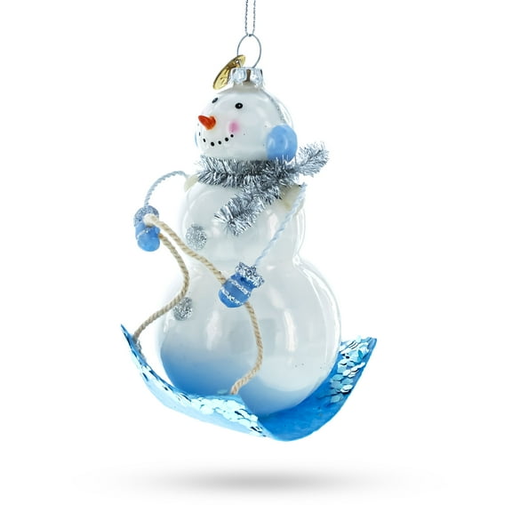 Snowman Riding a Sled Glass Christmas Ornament