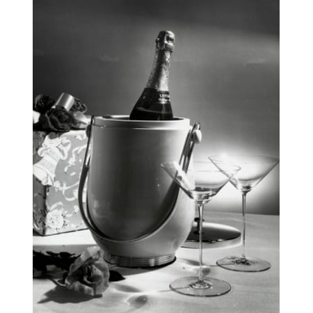 Champagne bottle in an ice bucket with two empty martini glasses beside it Canvas Art -  (24 x