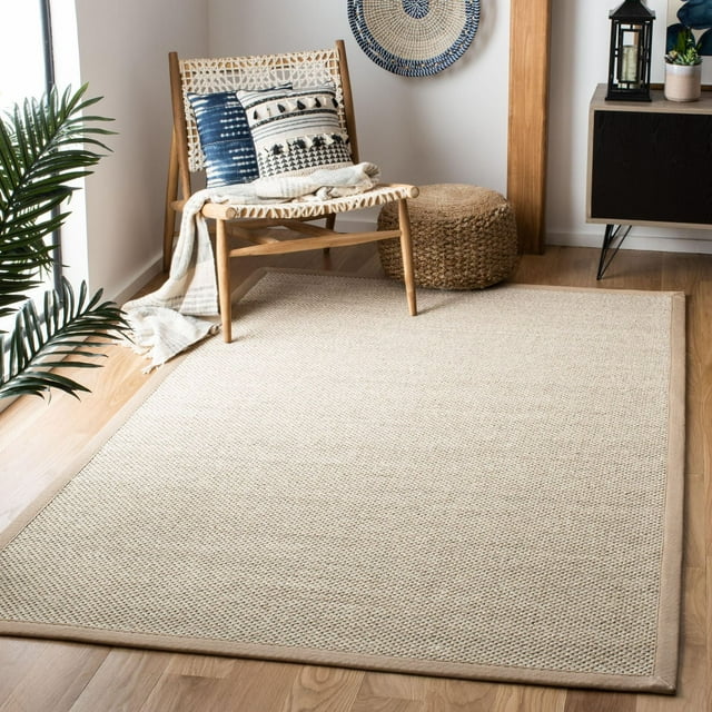 SAFAVIEH Natural Fiber Kentigern Border Area Rug in light beige with subtle border, displayed on wooden floor under woven chair and pouf.