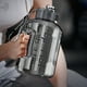 thumbnail image 1 of Taza de agua de gran capacidad Botella deportiva de plástico portátil de 1700 ml con pajita, cuerda de transporte y estuche de cuero - Trendy Outdoor Fitness Hidratación para estudiantes y adultos, 1 of 5
