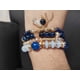 thumbnail image 4 of Set de 4 pulseras en colores azul rey, varios modelos con dije, 4 of 7