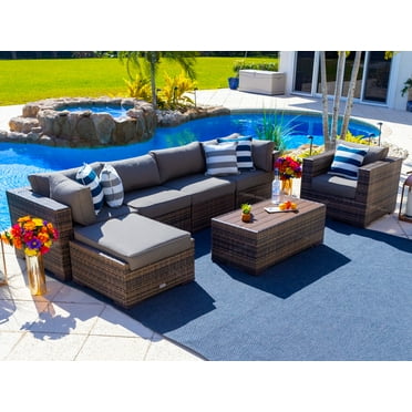 Sorrento 7-Piece Resin Wicker Outdoor Patio Furniture Sectional Sofa Set in Brown w/ Four Sectional Pieces, Ottoman, Armchair, and Coffee Table (Flat-Weave Brown Wicker, Sunbrella Canvas Charcoal)