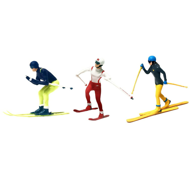 Miniature skiers in action - white background, copy space Stock Photo