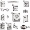 thumbnail image 1 of 56 piezas de 14 estilos de dijes de libros plateados de metal con temática de biblioteca escolar, colgantes para libros, tazas de café, cuadernos, gafas, dijes de estudio, 1 of 5