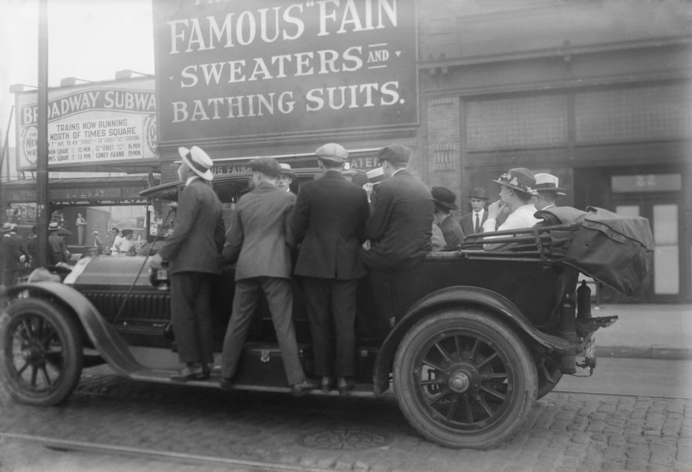 Men Ride On The Running Boards Of A Improvised Mass Transit Vehicle