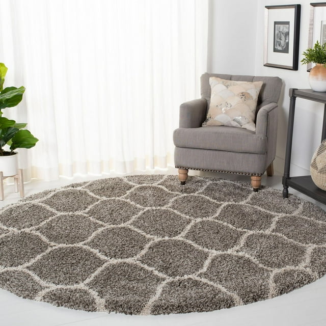 Round Safavieh Hudson Arline shag area rug in gray with white geometric trellis pattern, styled in living room setting.