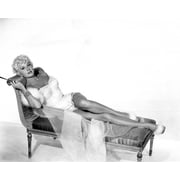 Rhonda Fleming glamour pose lying on sofa showing legs 8x10 inch photo