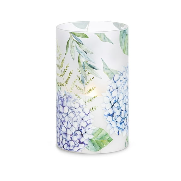 LED 5"D X 8"H Hand-Poured Wax Candle w/ Floral Design. Next Gen LED Flame Patented Technology w/ Adjustable Brightness Control. 2 C Batteries (Not Included). Multi Timer Function, 4, 6 & 8 hour.
