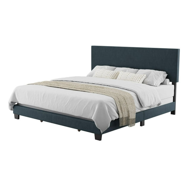 CorLiving Celeste modern king bed frame upholstered in dark blue fabric featuring a tall headboard, shown with white bedding and beige throw blanket.