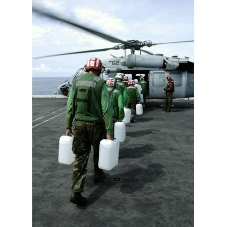 LAMINATED POSTER Sailor's aboard USS Abraham Lincoln (CVN 72) load jugs of purified water on board an awaiting MH-60S Poster Print 24 x