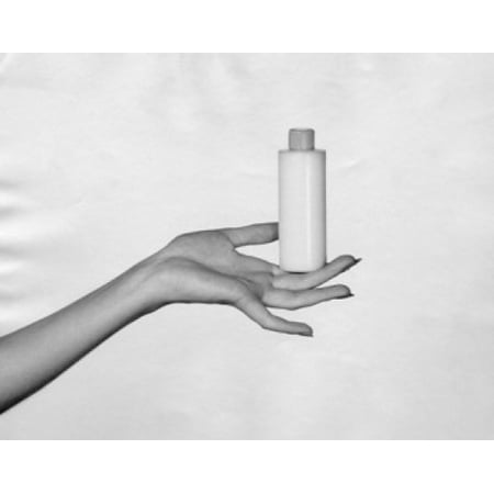 Close-up of a womans hand holding a bottle of moisturizer Canvas Art - (18 x 24)