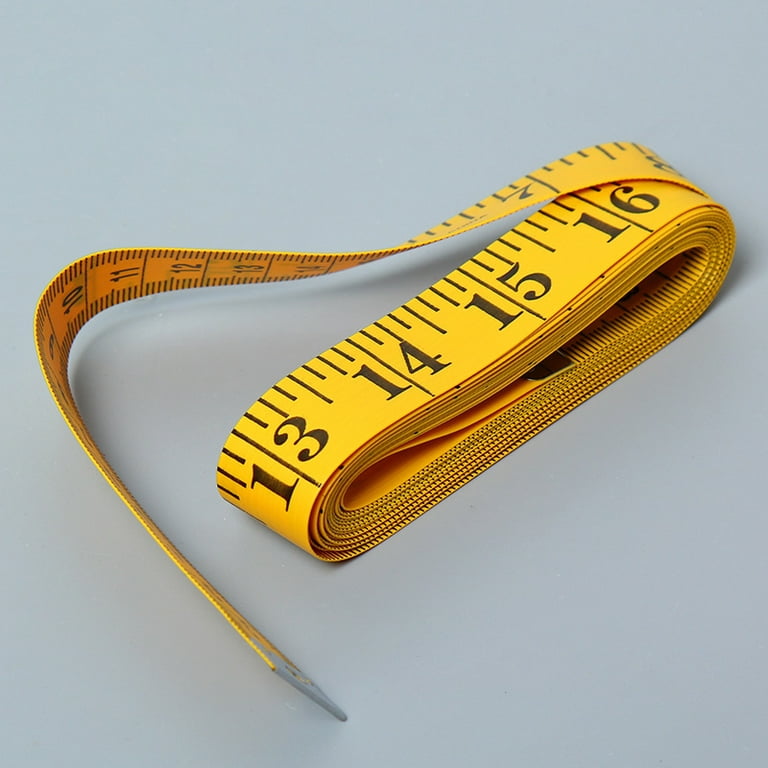 Top view of yellow soft measuring tape. Minimalist flat lay image of tape  measure with metric