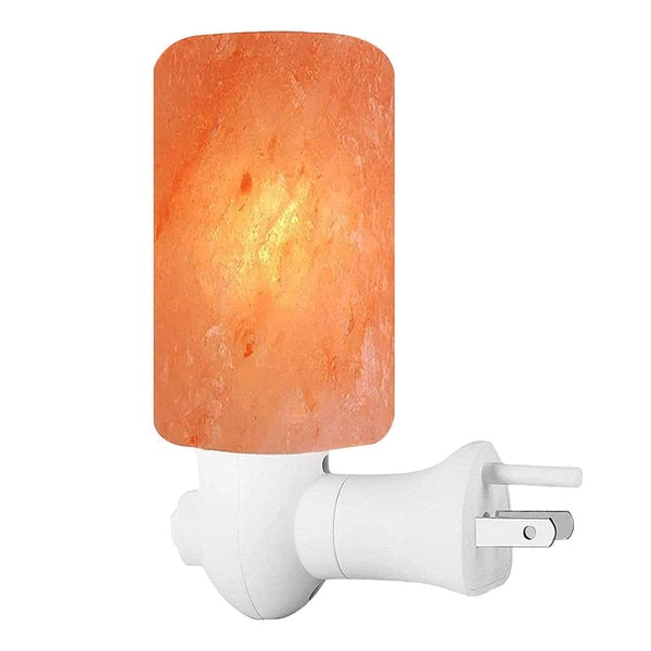 Pink Salt Crystal Light - Cylinder by Pride of India, featuring a cylindrical design carved from natural Himalayan pink salt crystals. The lamp emits a warm reddish-orange glow and is mounted on a white plug-in base. Ideal for creating a calming ambiance, it serves as both a decorative piece and a natural air purifier. Suitable for home décor or gifting on occasions like anniversaries or housewarming parties.