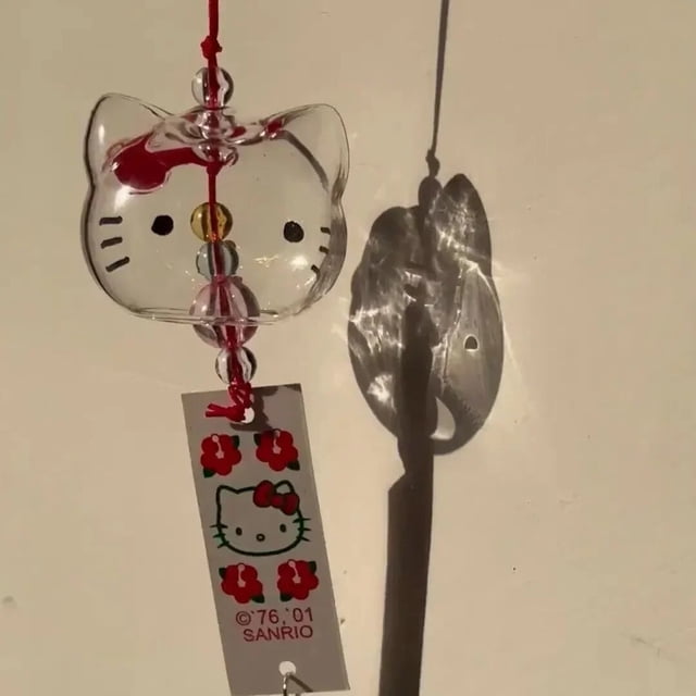 campana de viento kawaii de cristal de hello kitty Preventa — campanilla colgante de vidrio con forma de cabeza de Hello Kitty, cuentas transparentes internas y cordón rojo, etiqueta Sanrio visible; piezas separadas para montaje manual al recibir, adecuada para decorar dormitorio o como regalo romántico.