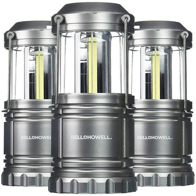 Bell + Howell TacLight Black 3 Pack Portable Survival Lanterns with collapsible grey bodies, clear plastic upper housing with vertical yellow COB LED strips, and metal handles for hanging, ideal for camping, emergencies, and power outages.
