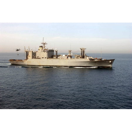 Military Sealift Command Ships - LAMINATED POSTER An SH-60 Seahawk helicopter picks up ordnance from the Military Sealift Command ammunition ship USNS Poster Print 24 x 36