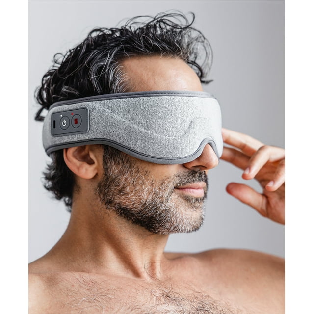 Homedics Massaging Eye Mask in grey, worn on the head, designed for eye strain relief and relaxation. Features soothing heat therapy, adjustable vibration nodes, and three massage programs—Deep Rest, Gentle Balance, and Dynamic Soothe. Made with ultra-soft materials for comfort and a snug fit, offering a 3-hour runtime for extended use.
