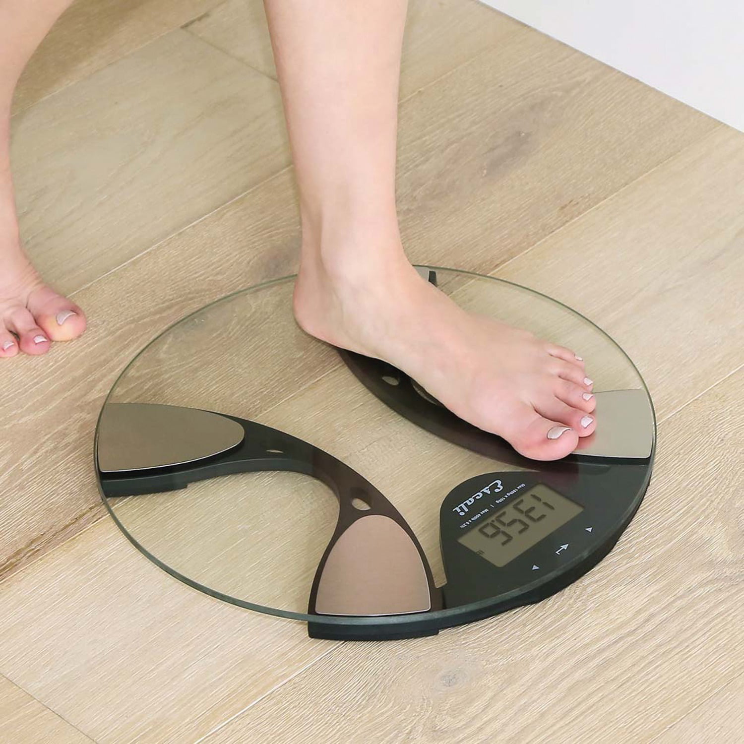 Woman bare feet standing on a digital scale with body fat analyzer that  uses bioelectrical impedance (BIA) to gauge the amount of fat in your body  Stock Photo