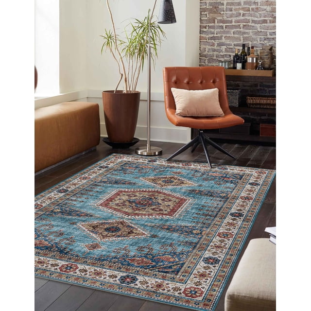 Traditional area rug featuring blue background with beige and red geometric motifs placed on dark hardwood floor in a contemporary living room.