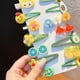 thumbnail image 2 of Juego de 14 horquillas con diseños de flores y frutas de colores para el cabello de niñas, inspirado en princesas y temática verde, 2 of 5