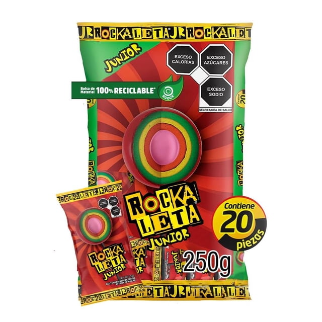 paleta sonric´s rockaleta junior enchilada 20 pzas de 12.5 g c/u bolsa con 20 piezas; empaque rojo y verde con logo Rockaleta Junior, paleta redonda mostrada en primer plano con capas verde, amarillo y naranja y centro de goma de mascar rosado; incluye sellos de advertencia exceso calorías/azúcares/sodio y mención de bolsa de material 100% reciclable. Ideal para compartir.