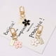thumbnail image 2 of Juego de 3 llaveros de flores para mujer, pequeños, blancos, negros, rosas, con margaritas, bonitos accesorios para llavero de coche para niña, 2 of 4
