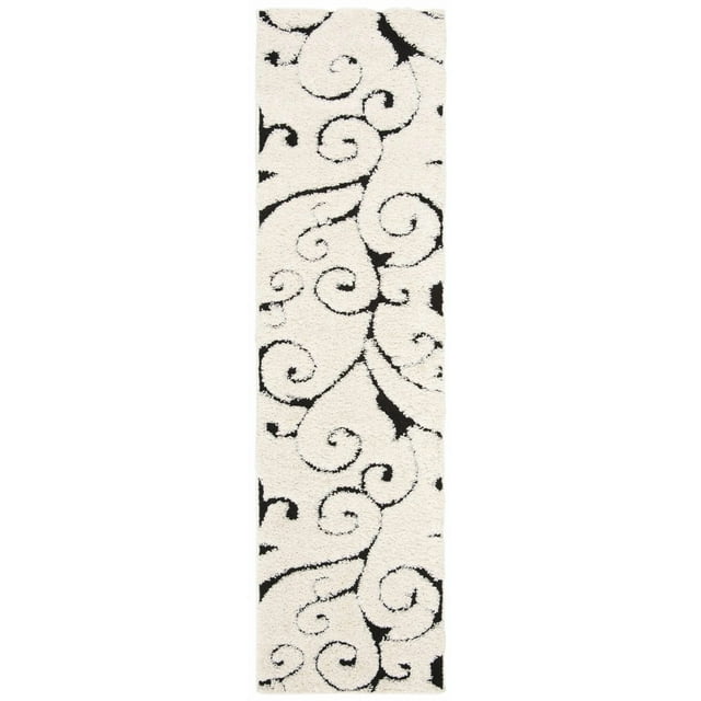 SAFAVIEH Florida Douglas shag area rug featuring black floral vine swirl patterns on a white background.