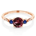 thumbnail image 2 of Gem Stone King 10K Rose Gold Red Rhodolite Garnet Blue Created Sapphire and White Diamond Accent 3-Stone Engagement Ring for Women (1.20 Cttw, Round 6MM, Gemstone January Birthstone, Size 5.5), 2 of 5