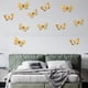 thumbnail image 4 of Pegatinas de pared de mariposas doradas - 12 piezas de decoraciones metálicas 3D para fiestas, cumpleaños y decoración del hogar | Calcomanías de pared extraíbles con puntos adhesivos, 4 of 5