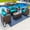 Sunbrella Canvas Aruba, variant on Tuscany 4-Piece M Resin Wicker Outdoor Patio Furniture Conversation Sofa Set with Loveseat, Two Armchairs, and Coffee Table (Half-Round Brown Wicker, Polyester Light Gray)