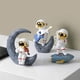 thumbnail image 5 of Adorno de astronauta YONGSHENG Kickball dorado, 5 of 5